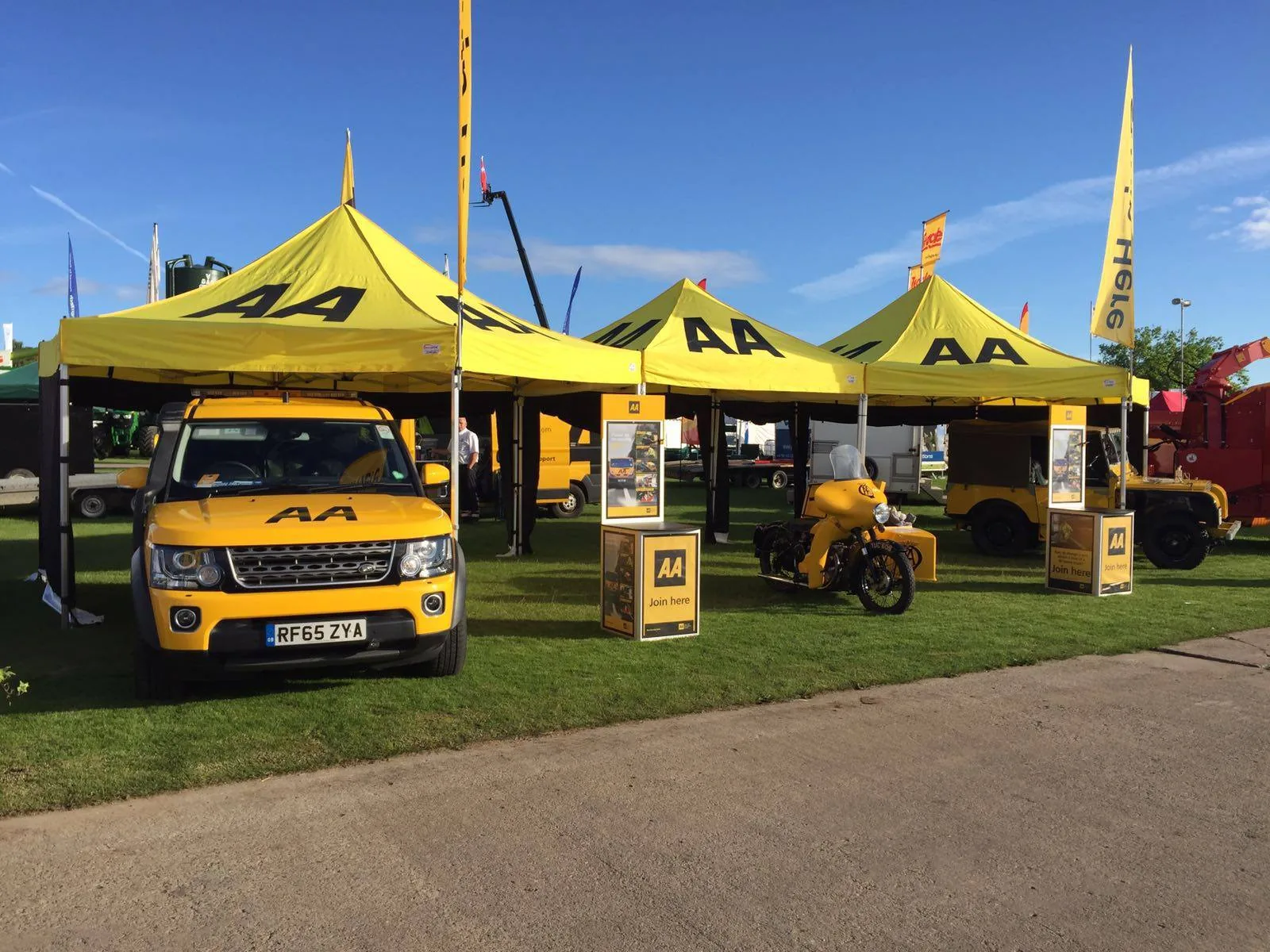 Row of premium pop-up gazebos at a sunny outdoor event